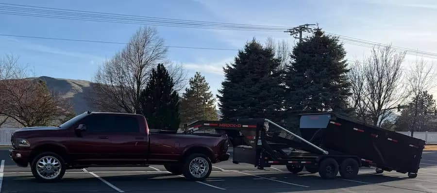 Barnes truck delivering a roll-off dumpster
